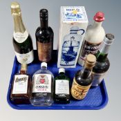 A tray containing eight bottles of alcohol, to include Cossack vodka, Cointreau, Gordon's gin,