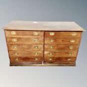 An early 20th century oak ten drawer haberdashery chest with brass drop handles,