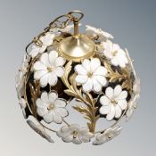 A contemporary brass light fitting decorated with glass flowers.
