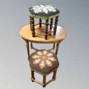 A oval beechwood occasional oval table together with two tapestry upholstered hexagonal foot stools.