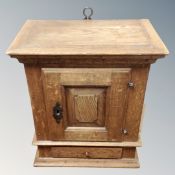 A 19th century oak panel door hanging wall cabinet, fitted drawer beneath.