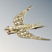 A gold and seed pearl swallow brooch, length 29mm. CONDITION REPORT: 3.3g.