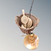 A retro style copper light fitting together with a wicker log basket containing brass beech-handled