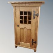 A late 19th century oak single door cabinet dated 1898,