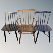 A 20th century Scandinavian stick back armchair together with two further stick back dining chairs.