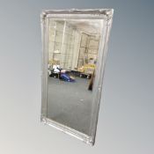 An ornate silvered mirror, length 136 cm.