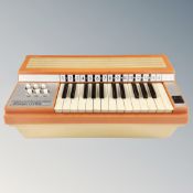 A Virtuoso Cortina Rosedale electric chord organ.
