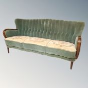 An Art Deco beech framed three seater settee upsholstered in a dralon fabric.