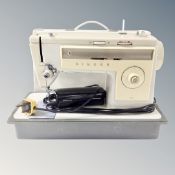 A Singer 513 electric sewing machine with foot pedal in case.