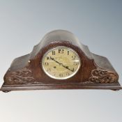 A 1930s carved oak cased Junghans eight day mantel clock.
