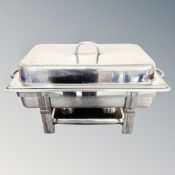 A stainless steel chafing dish with lid.