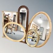 A blonde oak framed mirror together with four further framed mirrors.