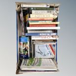 A box containing books and match day programs relating to Rugby and football.