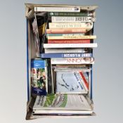 A box containing books and match day programs relating to Rugby and football.