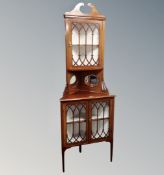 A Victorian inlaid mahogany double glazed corner cabinet.