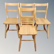 A set of four oak farmhouse style kitchen chairs.