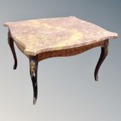 A French kingwood veneered shaped marble topped coffee table with gilt metal mounts,