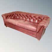 A 20th century Burgundy leather two seater club settee.