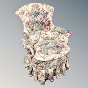 A 20th century lady's armchair upholstered in a floral fabric.