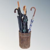 A wicker basket containing umbrellas