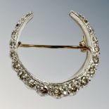 A 9ct gold diamond horse shoe brooch, set with seventeen brilliant-cut stones, largest 3.