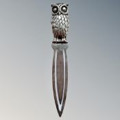 A silver bookmark in the form of an owl