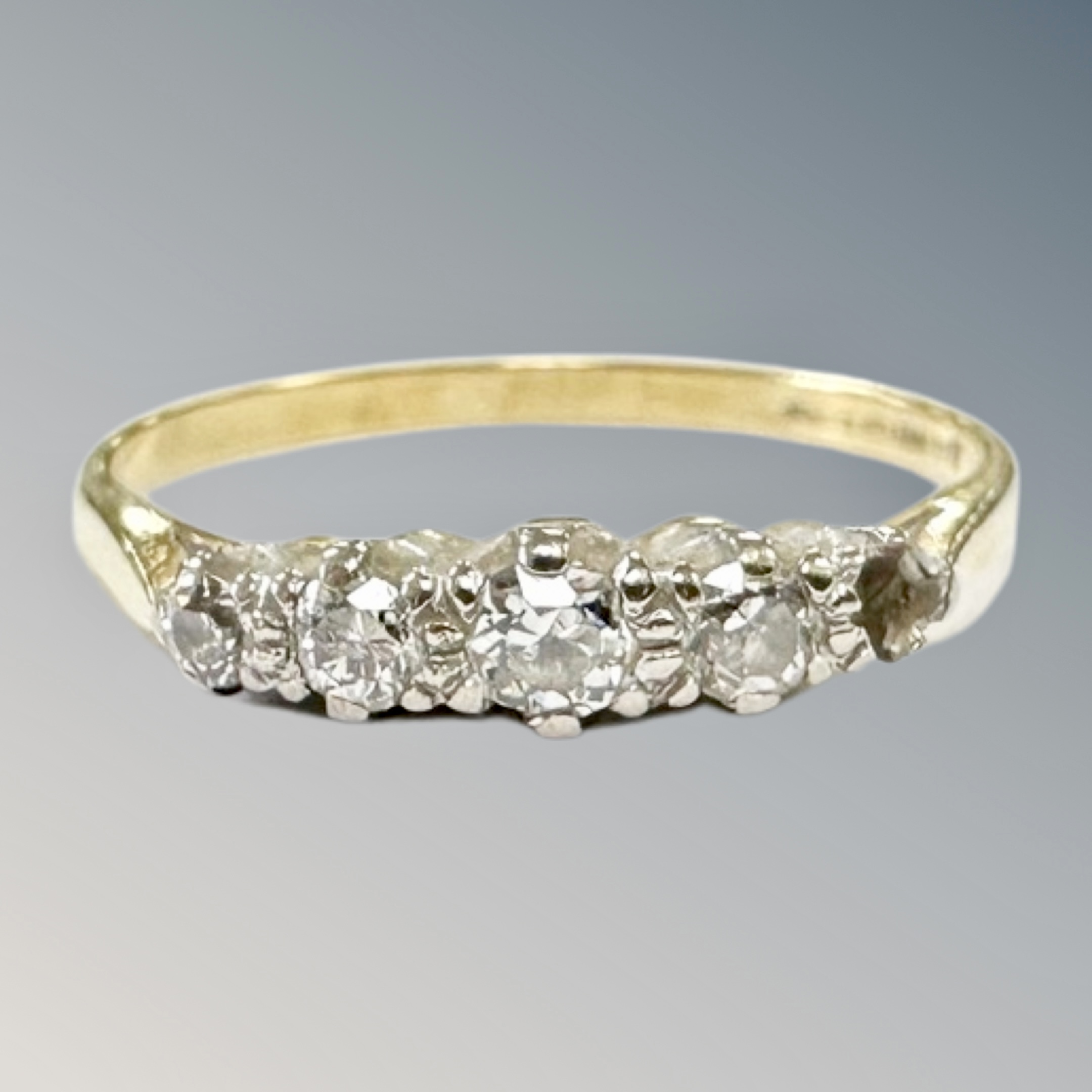 An 18ct yellow gold four stone diamond ring, size P, 2.2g.