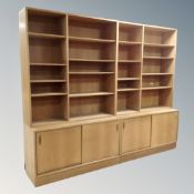 A 20th century Scandinavian twin section open bookcase fitted cupboards bellow in an oak finish.