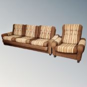 A 1970s three-seater settee and armchair upholstered in a brown buttoned fabric.