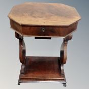A 19th century mahogany work table on paw feet.