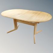 A late 20th century Scandinavian pine oval twin pedestal dining table.