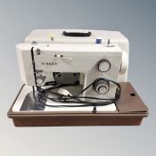 A Singer 5102 electric sewing machine in case.
