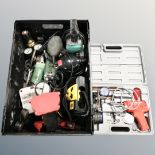 A box containing assorted power tools, battery charger and gauges.