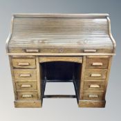 A late 19th century oak twin pedestal roll top desk.