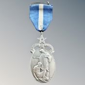 A silver Masonic medal designed by Charles Leighfield Doman depicting Charity, named to Bro. A. M.