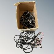 A box containing a quantity of hematite jewelry including necklaces and bracelets.