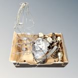 A box containing football trophies, wire metal tea light holder, chandelier.