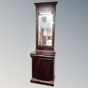 A 19th century mahogany side cabinet with pillar column supports and similar wall mirror above.
