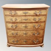 A 19th century inlaid walnut bowfront five drawer chest with ornate brass handles and escutcheons,