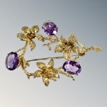 A 9ct gold amethyst floral bar brooch, length 46mm. CONDITION REPORT: 6.