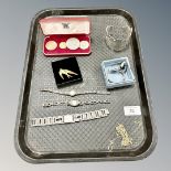 A tray of coins, marcasite wristwatches, enamelled swallow brooch, gilt metal chains, coins,