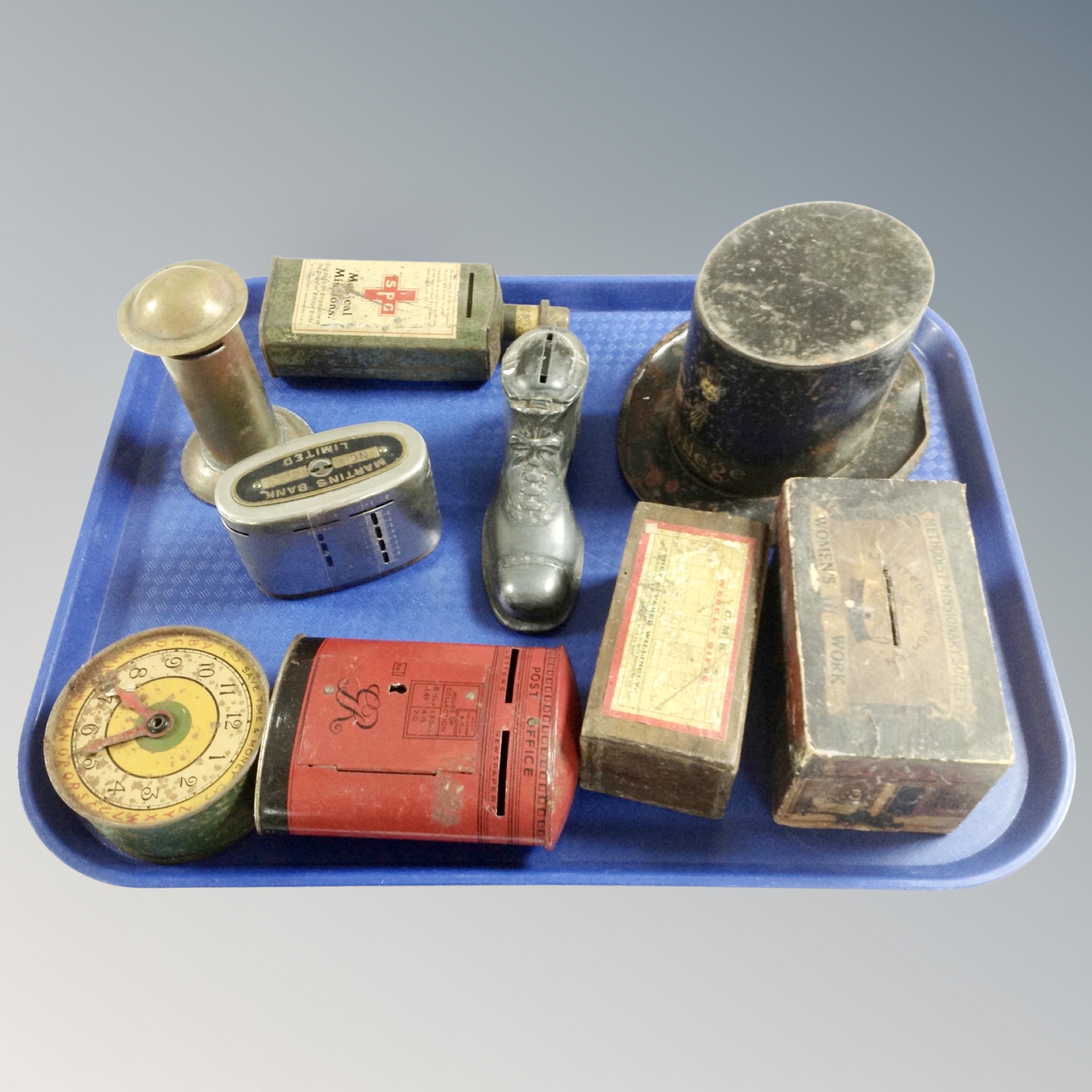 A tray of vintage money boxes, examples including a top hat, postbox, medical bottle,