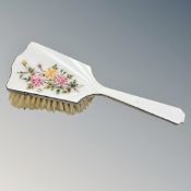 A silver and floral enamel dressing table brush