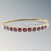 A 9ct gold ruby and diamond bangle,