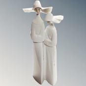 A Lladro figure of two nuns.