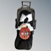 A bowling ball and pair of bowling shoes in bag.