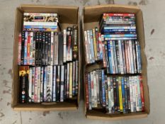 Two boxes of DVDs - approximately 100.