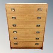 A mid 20th century Scandinavian six drawer campaign style chest with brass drop handles,