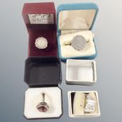 Two silver coin inset rings, a buckle ring and one further ring.