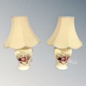 A pair of Aynsley Orchard Gold table lamps with shades.